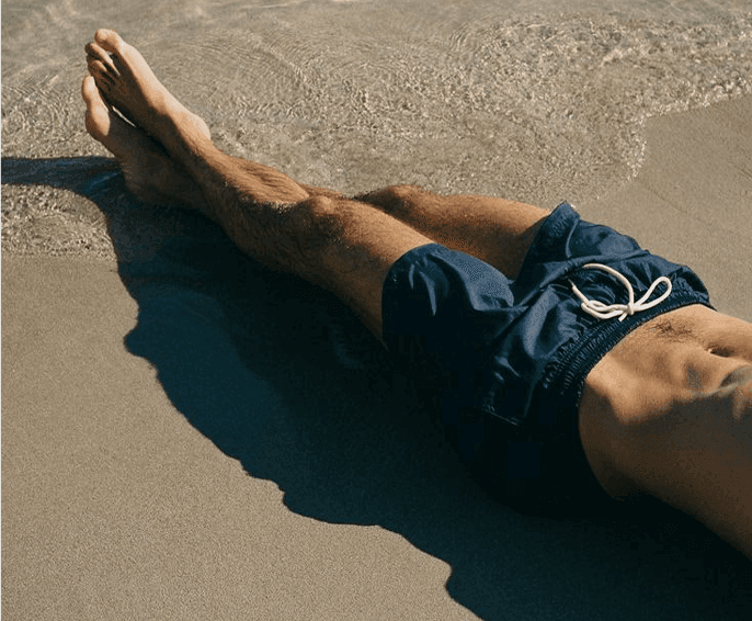 Swimwear - Fedeli swimwear navy swim shorts worn on a Mediterranean shoreline.