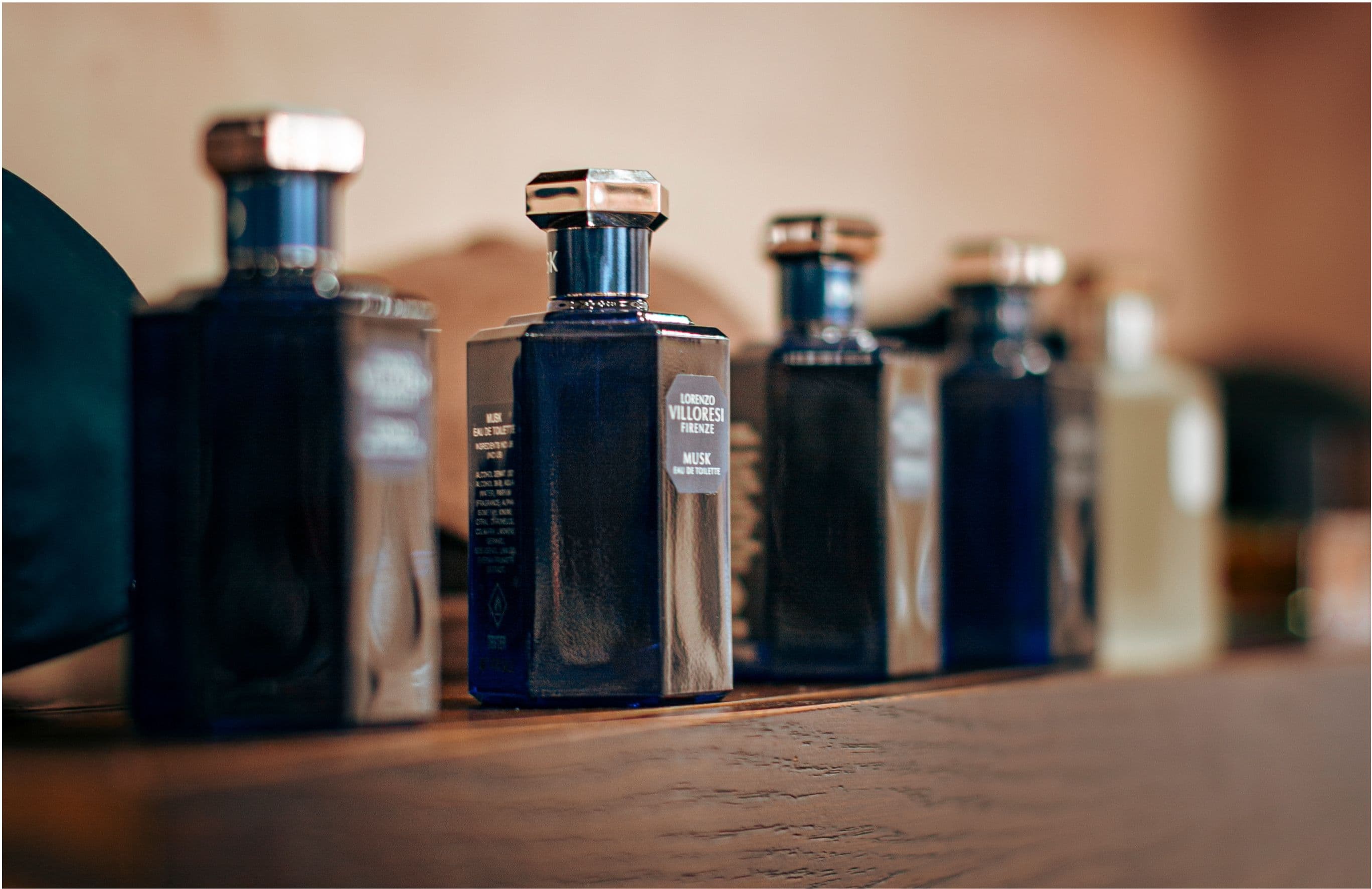 Shop fragrance — Lorenzo Villoresi Firenze cologne bottles lined on a wooden shelf.