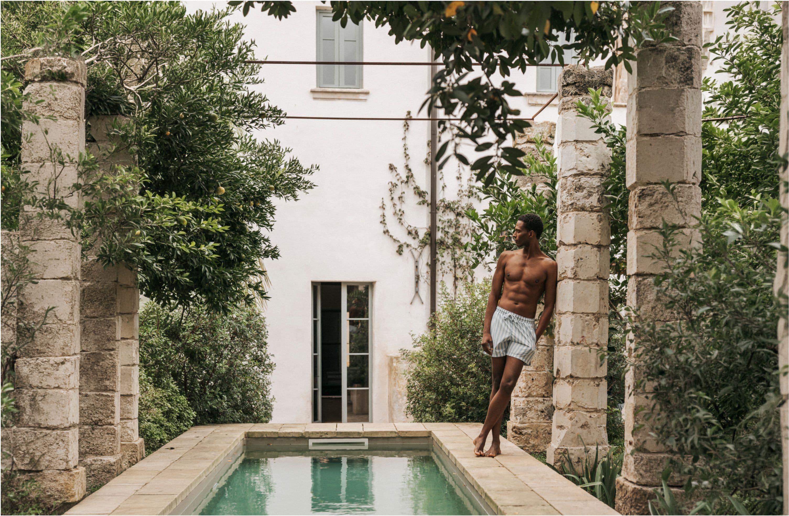 Spring summer 2026 Fedeli striped swimming trunks worn poolside at a Mediterranean villa